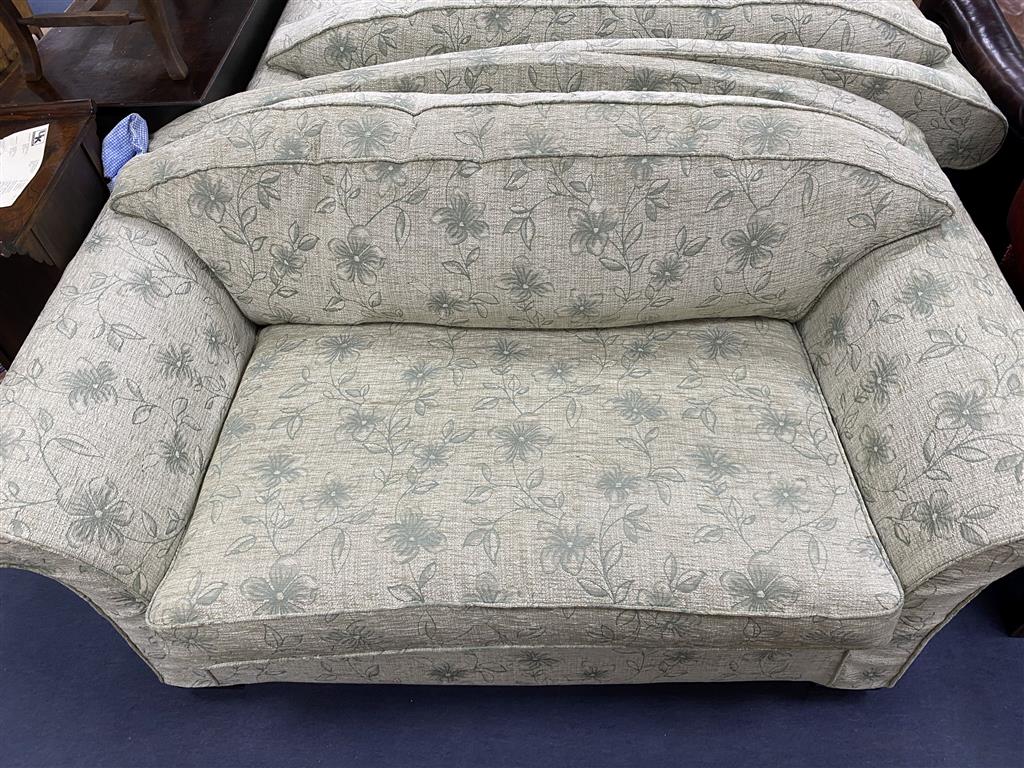 A pair of modern green floral upholstered two seater settees, length 164cm, depth 93cm, height 82cm